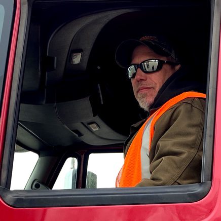 Driver sitting in red truck