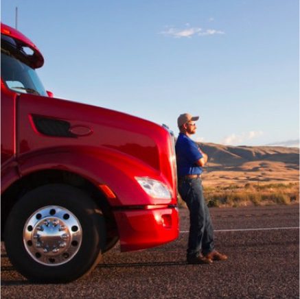 Driver leaning next to red truck