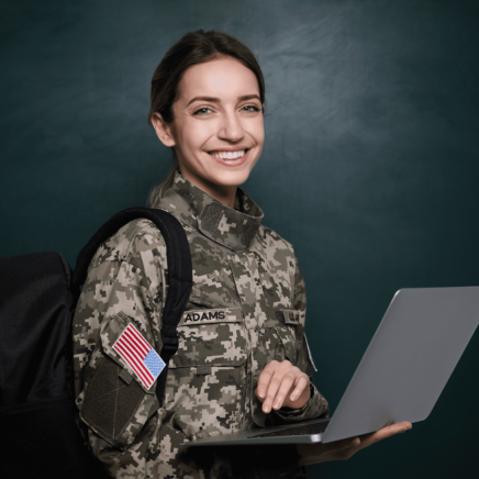 Young military woman in uniform smiling with a laptop