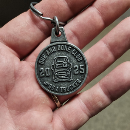 silver keychain that says one and done